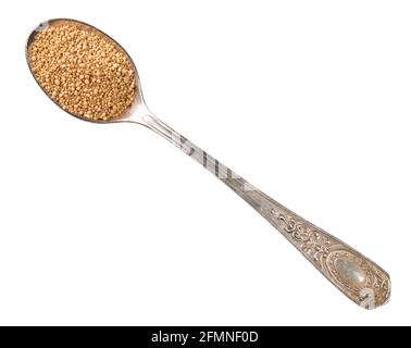 top view of granulated active dry yeast in silver teaspoon cutout on white background Stock Photo