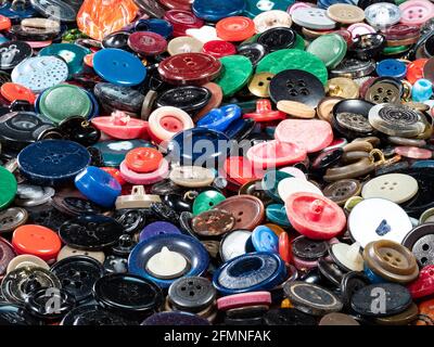 many various used buttons on surface of table closeup Stock Photo