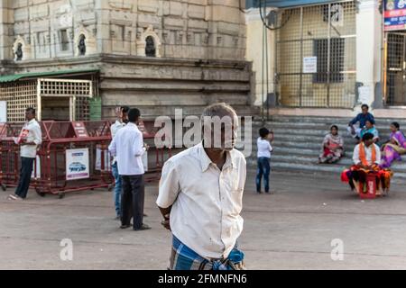 Mysuru, Karnataka, India - January 2018: An elderly Indian man staring sadly outside an ancient Hindu temple in the Chamundi Hills in Mysore. Stock Photo