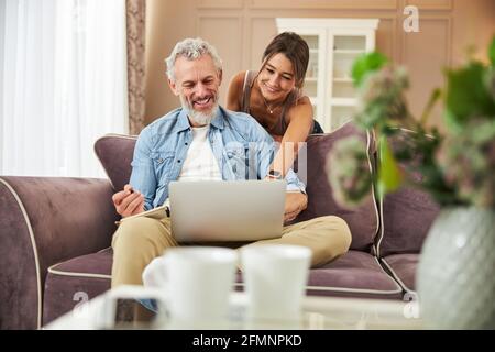 Delighted bearded man using his new gadget Stock Photo