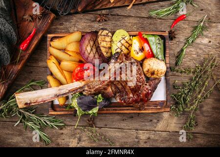 Grilled beef tomahawk steak with vegetables Stock Photo