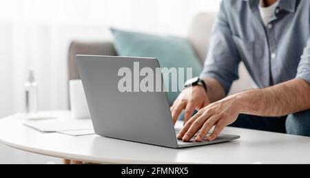 Working at laptop pc. Male hands on pc keyboard, typing text or programming code in computer Stock Photo