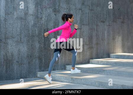 African woman in sport clothes jogging outdoor Stock Photo