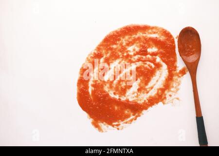 tomato sauce and a wooden spoon on white background  Stock Photo