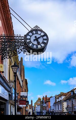 Antique clock above shop buildings on Preston Street, Faversham, England, UK Stock Photo