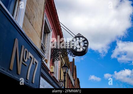 Antique clock above shop buildings on Preston Street, Faversham, England, UK Stock Photo