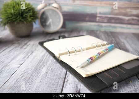 open notepad and pen on paper on wooden background  Stock Photo