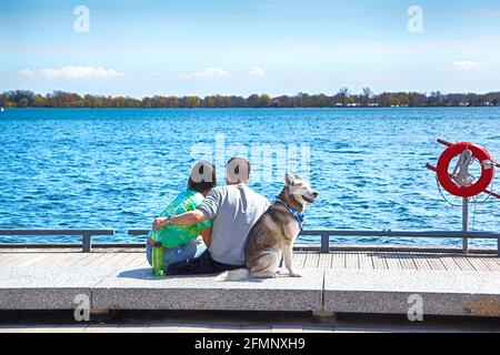 Happy couple in love enjoying their time with pets in nature. Stock Photo
