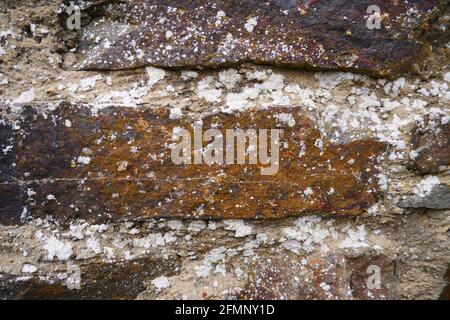 macro shot of a medieval castle wall made from old brown stone bricks Stock Photo