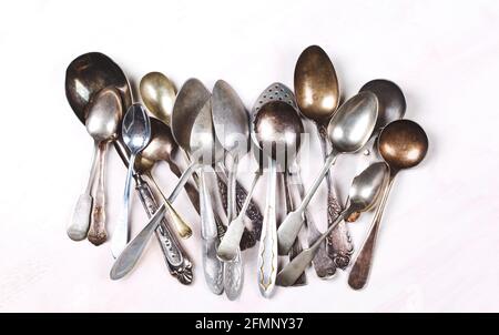 Old vintage spoons on white wooden background. Top view Stock Photo