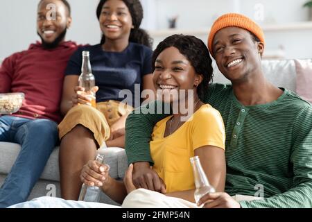 Joyful african american couples enjoying movie at home Stock Photo