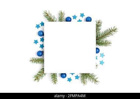 Paper card template with frame made of blue Christmas decorations and spruce branches. Festive mockup with place for text. Stock Photo