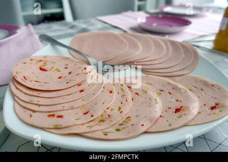 Oberkirch, Germany. 01st May, 2021. Slices of Lyoner and Paprikalyoner lie on a plate. Credit: Alexandra Schuler/dpa/Alamy Live News Stock Photo