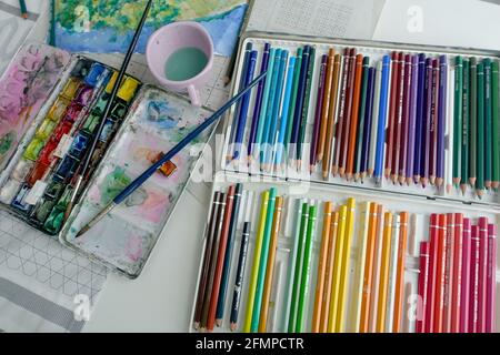 Oberkirch, Germany. 01st May, 2021. Watercolors and crayons lie on a table. Credit: Alexandra SchAuler/dpa/Alamy Live News Stock Photo