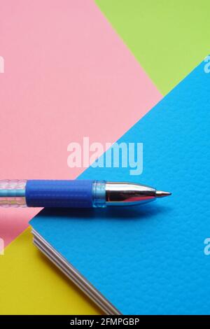 Blue ballpoint pen on different paper colors. Stock Photo