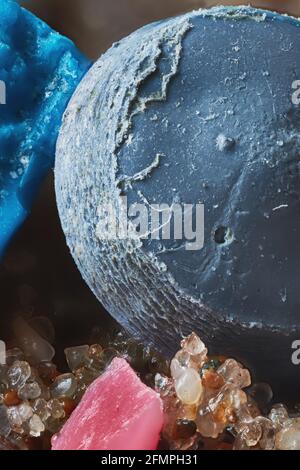 Extreme close up of microplastic nurdle found on beach Stock Photo