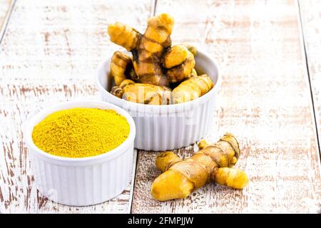 turmeric powder, root also known as turmeric, turmeric, sun root, turmeric and yellow ginger Stock Photo