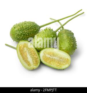 Group of fresh raw whole and halved wild cucumbers close up isolated on white background Stock Photo