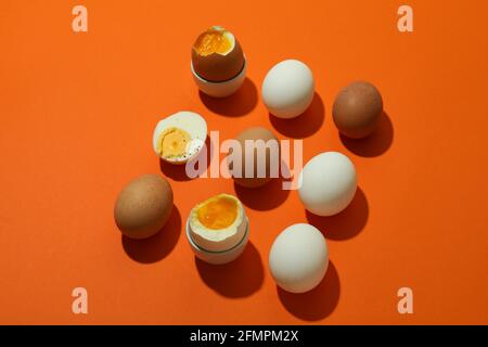 Flat lay with boiled eggs on orange background Stock Photo