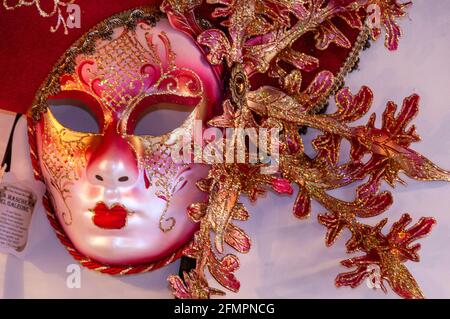 A display of Masquerade Ball Masks and Venetian Masks on sale in the town of Bardolino, a resort/fishing port in the red wine-growing region on the ea Stock Photo