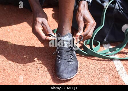 Timothy Cheruiyot, winner of the 1500 meters gold medal at the 2019 World  Athletics Championships in Doha, ties his shoes during a training session  in Nairobi, Kenya, May 8, 2021. Picture taken