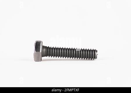 Photograph of a gray metal screw, a common piece in hardware stores anywhere in the world, used to fix any home or mechanical structure, isolated on a Stock Photo