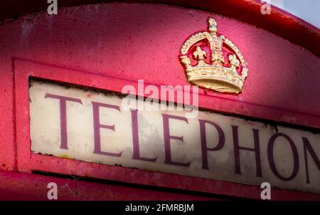 Top Of An English Red GPO Post Office Pay Telephone K6 Box With The Embossed Gold Tudor Crown. Christchurch UK Stock Photo