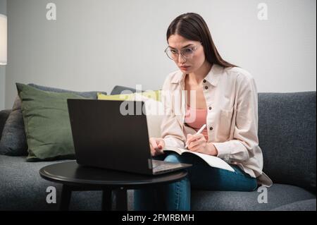 During lockdown in the covid-19 quarantine, the manager conducts a video conference from home using a laptop. Stock Photo
