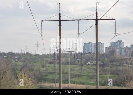 Electric pole and Power cable clutter high voltage poles with wires on the background of city houses Stock Photo