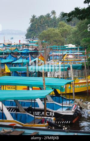 PANAJI, INDIA - November 06, 2011. Colorful tourist boats moored on Nerul River, Candolim, Goa Stock Photo