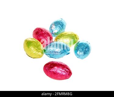 Chocolate easter eggs covered with brightly colored foil wrappers isolated on white Stock Photo