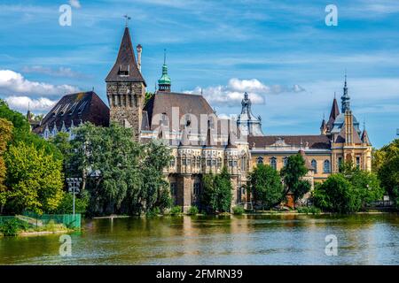 Budapest Vajdahunyad Castle viewed from its lakeside with two pretty young girls in a rowboat Stock Photo