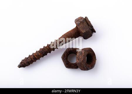 old rusty aged bolt, not usable, rusty item on white background  Stock Photo