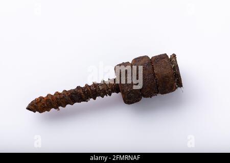 old rusty aged bolt, not usable, rusty item on white background  Stock Photo