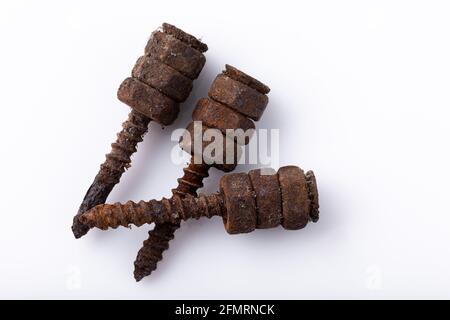 old rusty aged bolt, not usable, rusty item on white background  Stock Photo