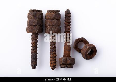 old rusty aged bolt, not usable, rusty item on white background  Stock Photo