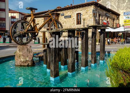 Cabezon De La Sal, Spain - August 24, 2016: Bicycle roundabout in the Plaza de la Paz in the Cantabrian town, a monument made in wood, with wheels of Stock Photo