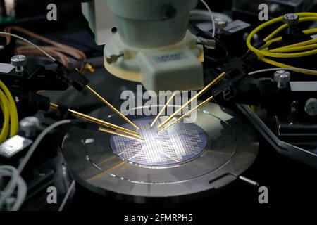 Semiconductor silicon wafer under test on the probe station. Selective focus.