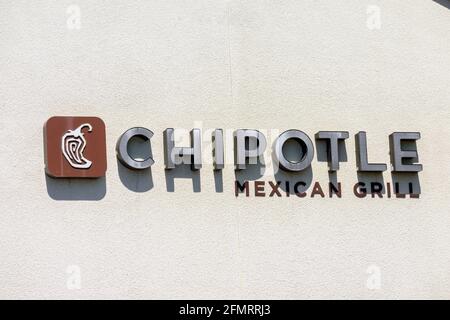 Chipotle Mexican Grill sign and logo above the chain restaurant location - San Jose California, USA - 2021 Stock Photo