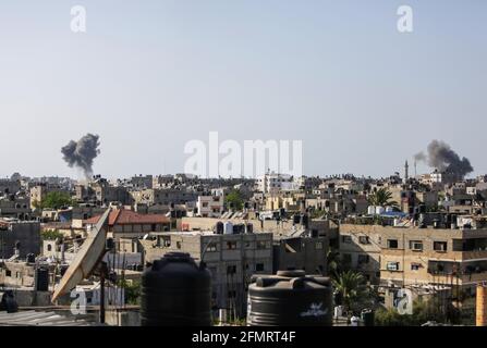 Gaza, Palestine. 11th May, 2021. Smoke seen over Gaza City after an Israeli air strike. The Ministry of Health in Gaza announced that at least 26 people, including nine children, were killed. (Photo by Mahmoud Issa/SOPA Images/Sipa USA) Credit: Sipa USA/Alamy Live News Stock Photo