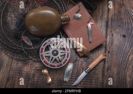 Vintage fishing still life. Fishing things on the table. Knife and tackle