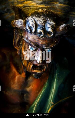 Church of Saint Mary Magdalene, famous demon at the entrance of the door - Rennes le Chateau - France Stock Photo