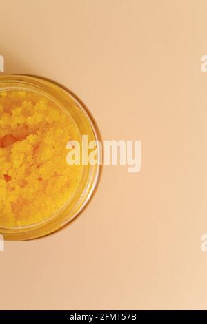 Body scrub of sea salt with lemon, rosemary and olive oil in glass jar on stone table, homemade cosmetic for Spa care Stock Photo