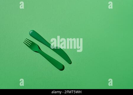Plastic fork and knife on match background Stock Photo