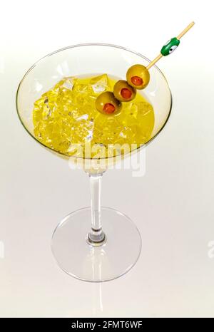 Close-up of cocktail martini with olives on table against isolated on white Stock Photo