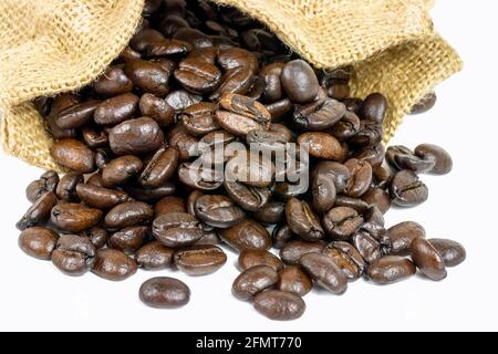 Roasted coffee beans in jute sack on white background Stock Photo