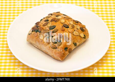 pipes pumpkin bread, presented on plate on tablecloth background Stock Photo