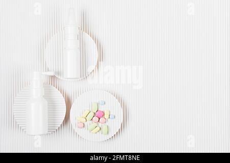 Medicine packs with the pile of pills on white corrugated paper background. Medicine or pharmacy concept. Copy space. Flat lay. Stock Photo