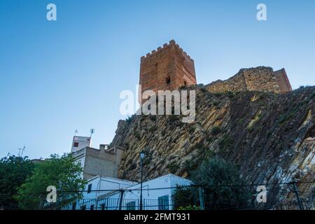 Castle of Sot de Chera on a rocky hill under the sunlight and a blue sky in Spain Stock Photo