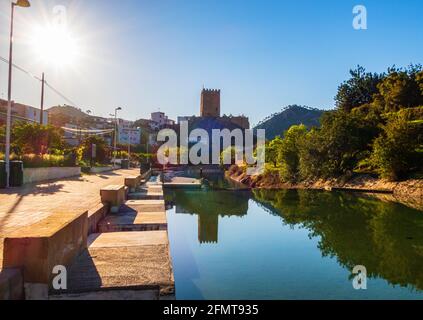 Landscape of a pool surrounded by greenery with the Castle of Sot de Chera in the background Stock Photo